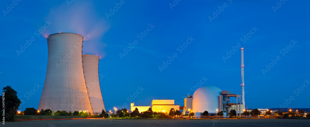 Cooling towers and the reactor dome of a nuclear power station at dusk